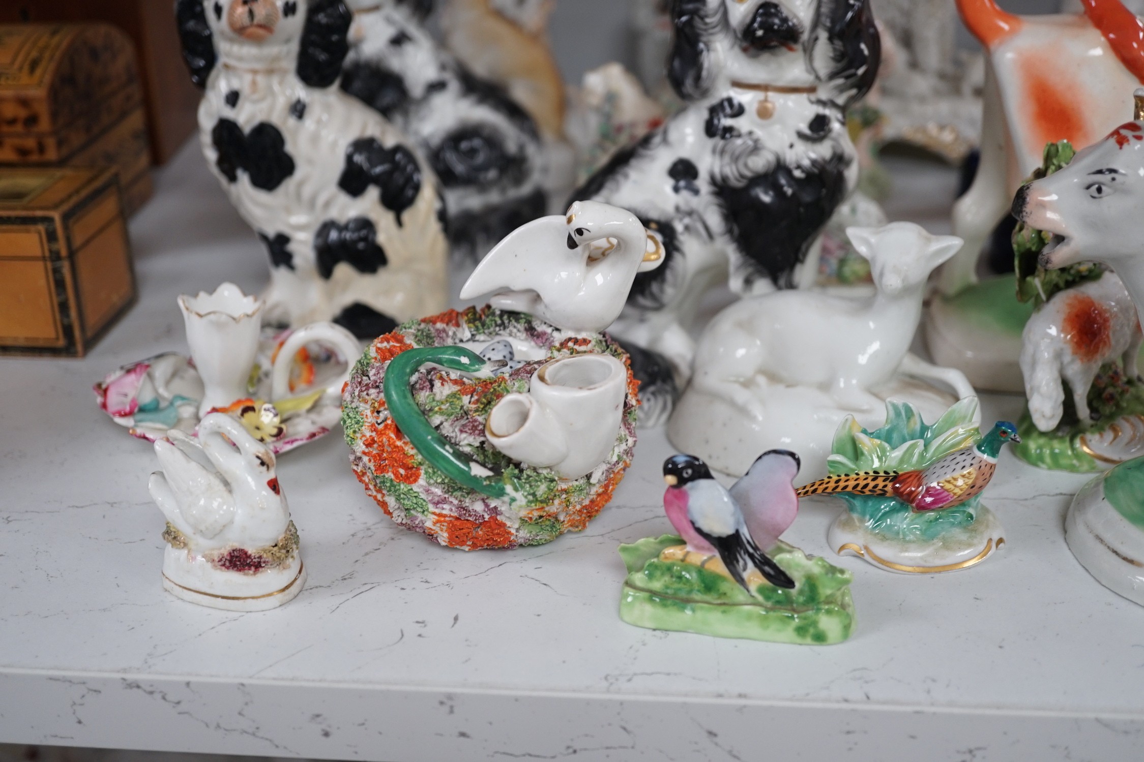 A quantity of Victorian Staffordshire animal figures, two pearlware putti and a Derby figure of a cherub, tallest 14.5 cm